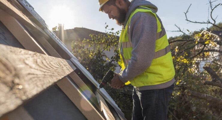 man-working-roof-with-drill-min